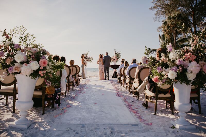 Luxurious Siesta Key beach wedding with King Louis chairs lining the aisle