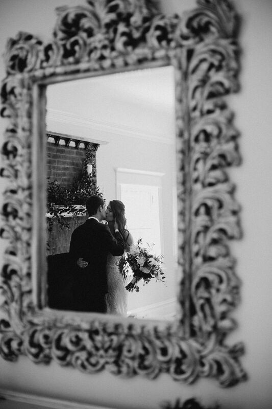 Reflection of bride and groom in a vintage mirror at The Orlo in Tampa