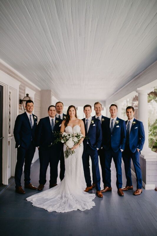 Bride, groom and groomsmen on the front porch of The Orlo in Tampa
