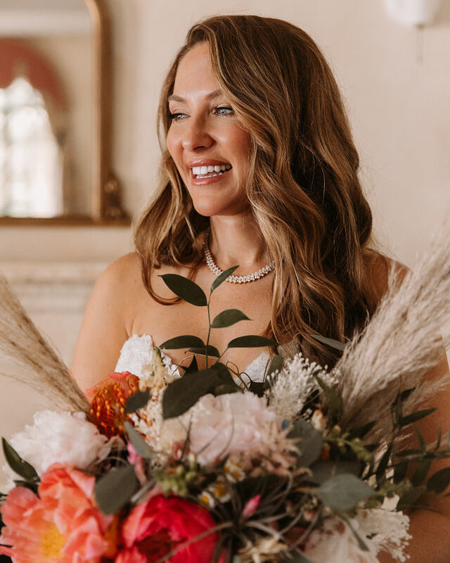 smiling bride holding her bouquet