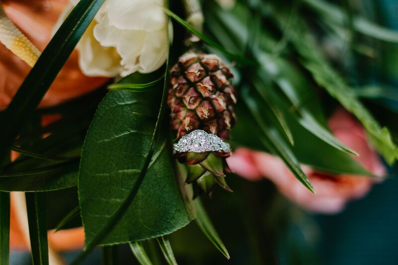 wedding ring resting on a miniature pineapple 
