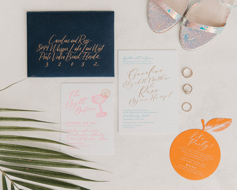 citrus and palm leaf wedding invitation with wedding rings