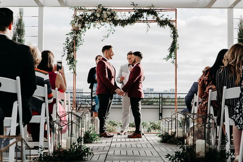 Tampa Wedding – Rooftop 220 – Armature Works- Jennifer Matteo Event Planning – Armature Works Wedding – Tampa wedding planner – Tampa LGBTQ wedding - rooftop wedding ceremony - to grooms - 
