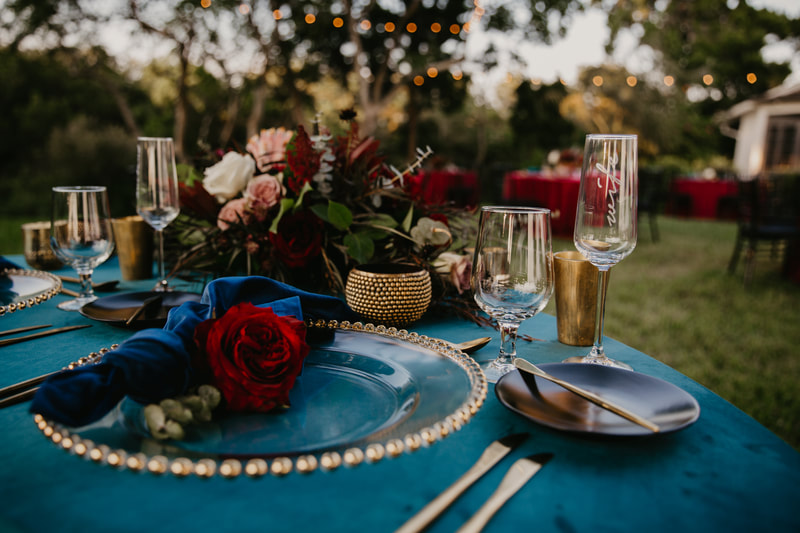 tablescape of rich jewel tones at Sarasota wedding reception at Marie Selby Gardens