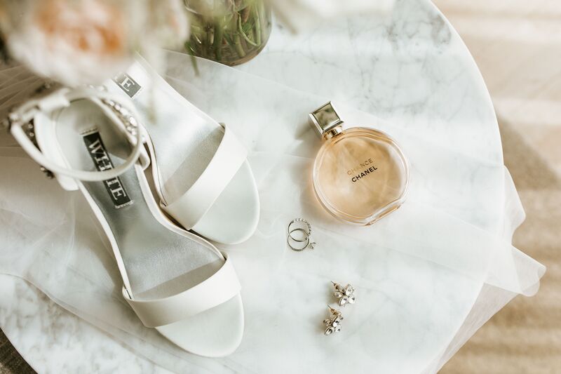 flat lay photo of a bride's shoes and wedding accessories