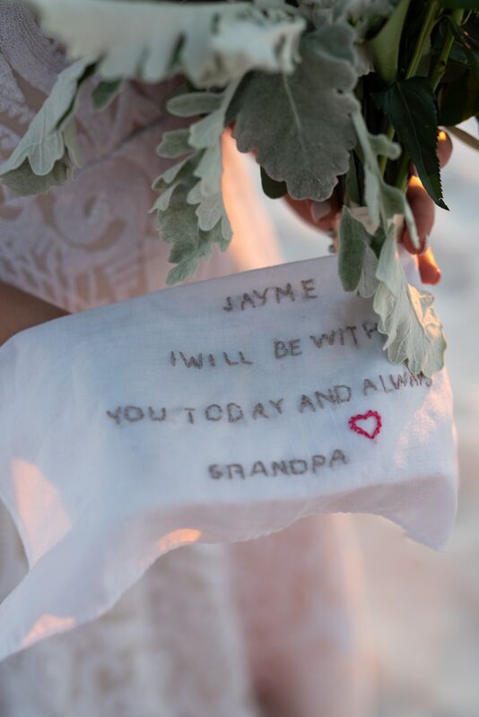 A hand stitched handkerchief with a note from the bride's grandfather