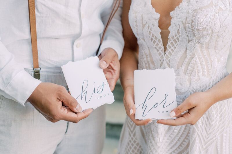 Siesta Key bride and groom holding His and Hers wedding Vow books