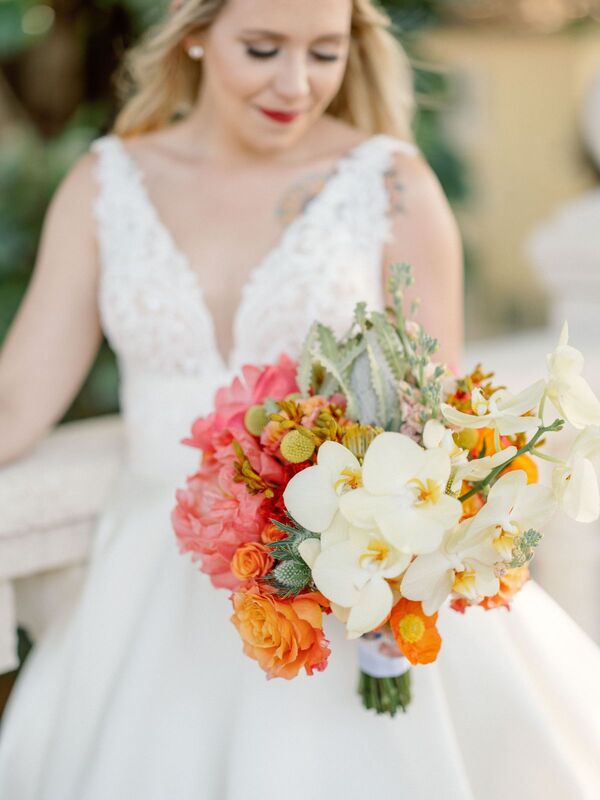 bride with a bright tropical colored bridal bouquet at her old Florida styled wedding at the Addison in Boca Raton