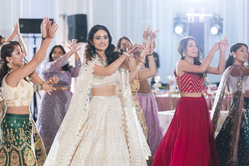 Indian bride and her bridesmaids during a dance performance at her Ritz Carlton Sarasota wedding reception