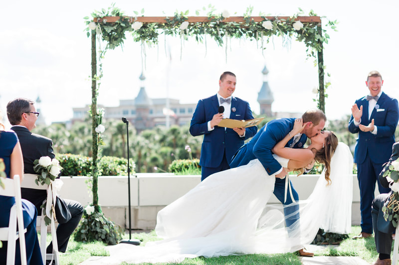 Jennifer Matteo Event Planning – Tampa wedding planner – Tampa wedding – downtown Tampa wedding – Kiley Gardens wedding ceremony- Armature Works wedding reception- first kiss - groom dipping bride for first kiss