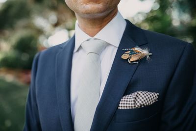 Jennifer Matteo Event Planning – Sarasota Wedding Planner- Selby Garden Wedding -rustic garden wedding - groom in blue suit - fishing fly boutonnière 
