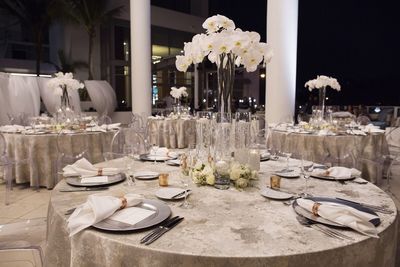 Jennifer Matteo Event Planning  - Sarasota wedding planner- Westin Sarasota – rooftop wedding- rooftop wedding reception - tall white orchid centerpieces