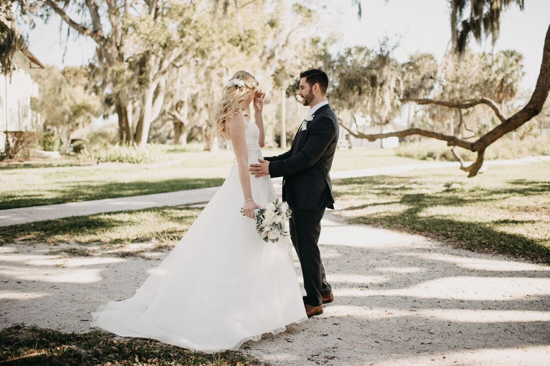 Sarasota wedding – Edson Keith Mansion wedding – Phillippi Estate Park wedding – Edson Keith Mansion – Phillippi Estate Park- Old Florida wedding – vintage inspired wedding – Sarasota wedding planner- Jennifer Matteo Event Planning- bride and groom - first look - first look under an oak tree