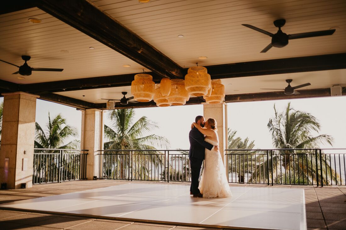 Bride and groom dancing on the terrace of the Ritz Carlton Beach Club in Sarasota, Florida