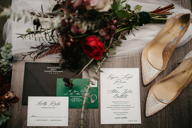flat lay poto of Sarasota couple's wedding invitation, details and shoes