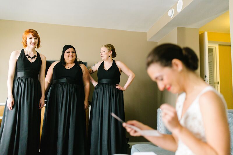 Jennifer Matteo Event Planning  - Pass A Grille wedding – Red Mesa Cantina wedding reception – Tropical wedding – St Petersburg wedding -
bride reading note from groom - black bridesmaids dresses