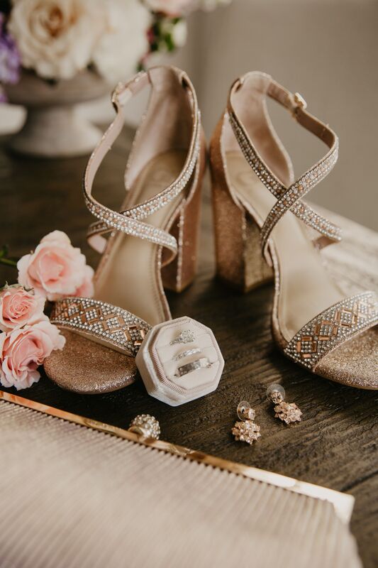 Flat lay photo of a Sarasota bride's wedding details including her rings and shoes