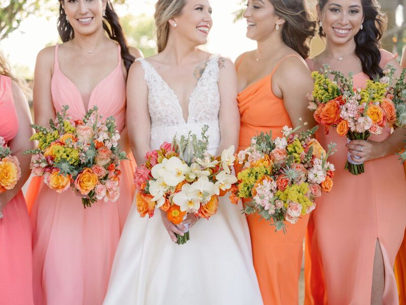 bride with her bridal part in bright citrus colored dresses