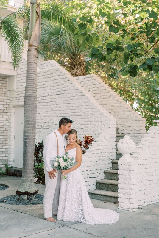 Siesta Key posing for wedding photos before their Sunset Beach Resort wedding