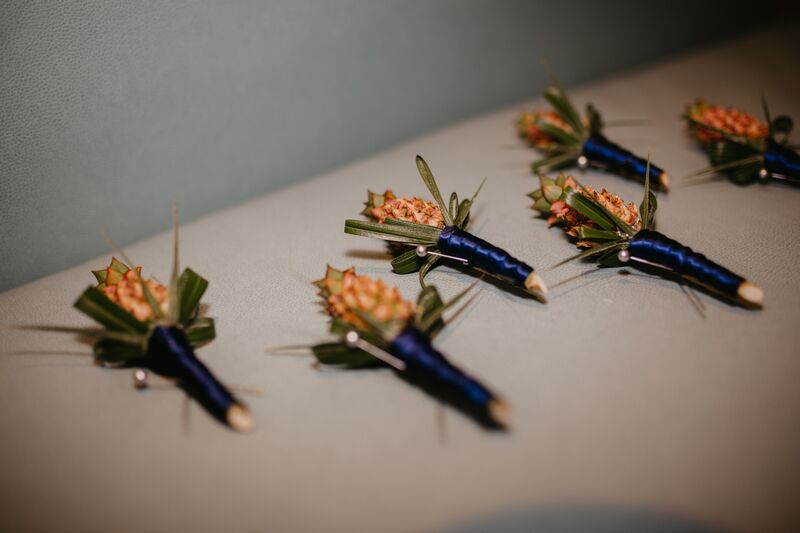 miniature pineapple boutonnieres for a tropical inspired wedding