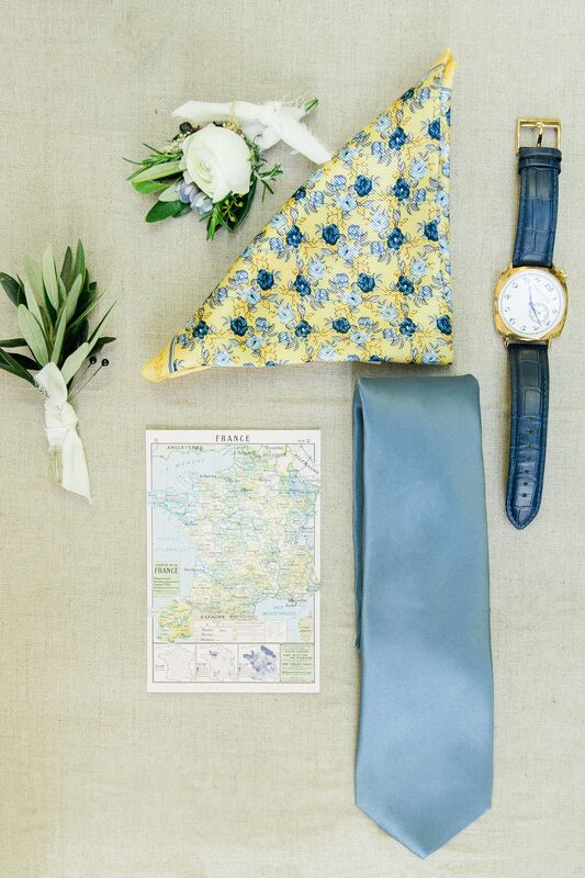 grooms accessories including his boutonniere, watch and tie
