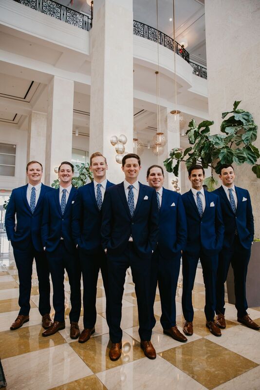 Groom and his groomsmen in blue suits heading to The Orlo for his wedding ceremony