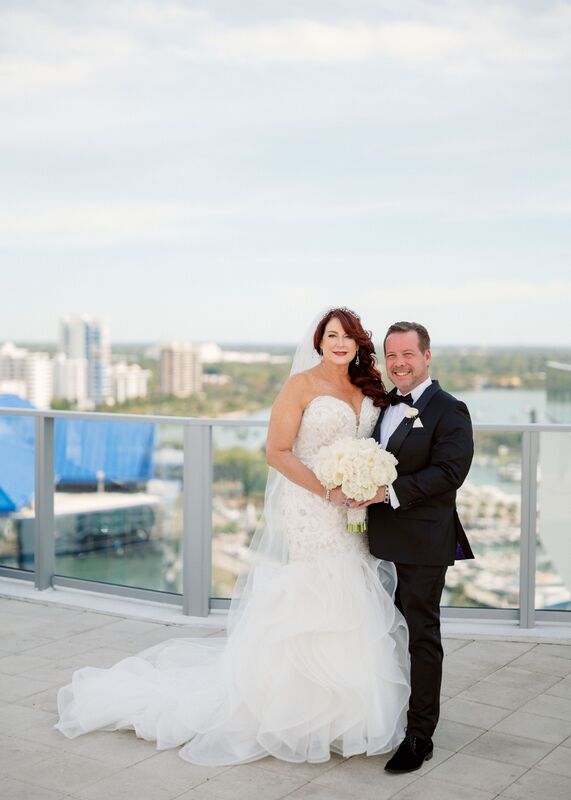 Bride and groom posing for photos on the rooftop of the Westin Sarasota