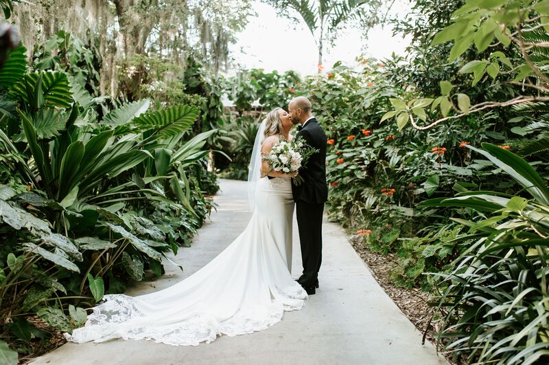 bride and groom posing for photos at Marie Selby Botanical Gardens