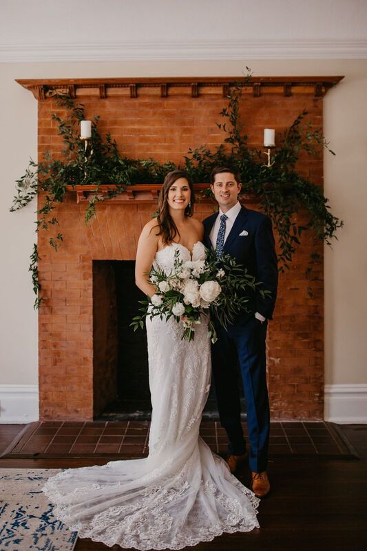 Bride and Groom in front of the brick fireplace at The Orlo in Tampa