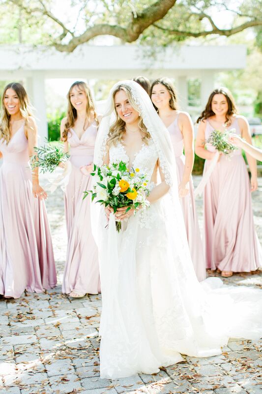 bride with bridal party wearing soft pink bridesmaids dresses