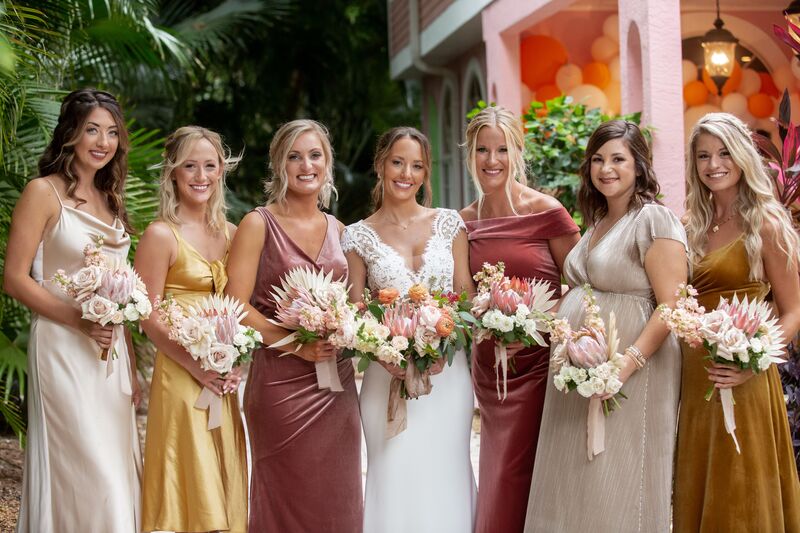 bride and bridal party in boho inspired wedding dresses