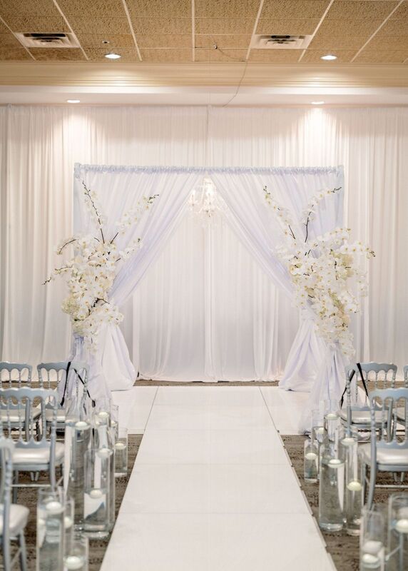 elegant white wedding structure with white floral swags