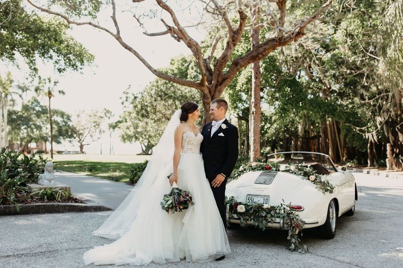 Sarasota Wedding Planner – Sarasota luxury wedding planner – Sarasota wedding – The Ringling - bride and groom with white Porsche convertible 