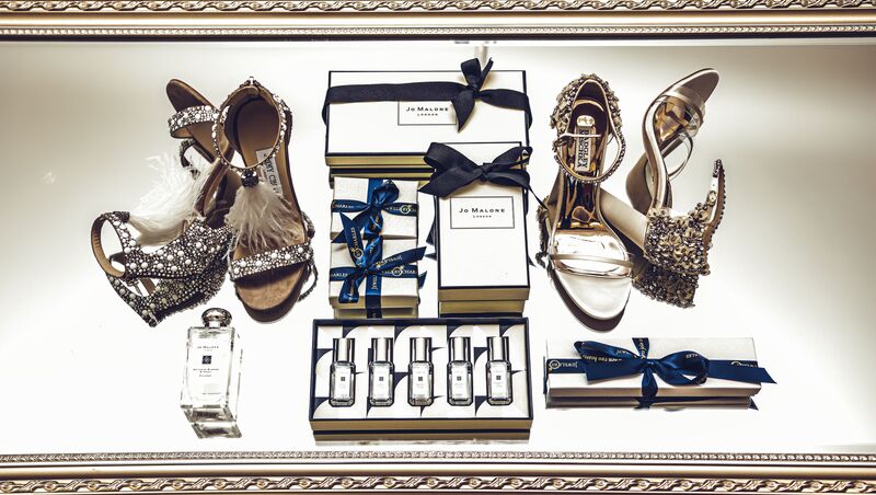Flat lay photograph of a brides wedding shoes and perfume
