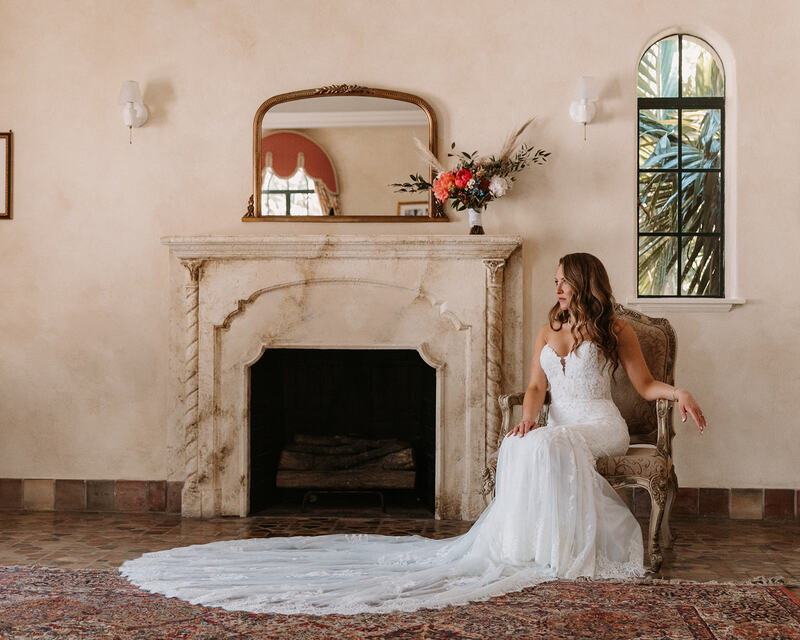 Bride sitting in a chair next to the fireplace at Powel Crosley Estate