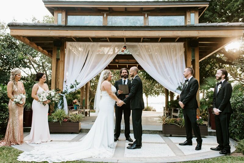 bride and groom exchange vows under a gazebo at Selby Gardens