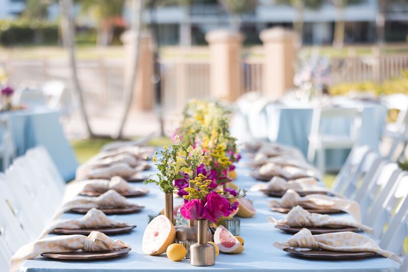long tables draped in soft seafoam linens with brightly colored florals and citrus for a Sangget at the Ritz Carlton Sarasota