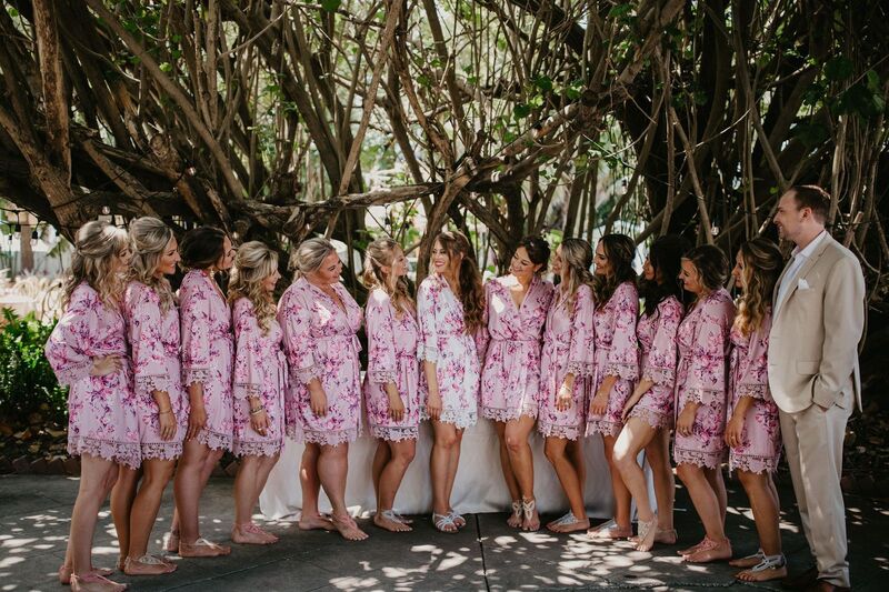 bride with wedding party wearing blush colored robes