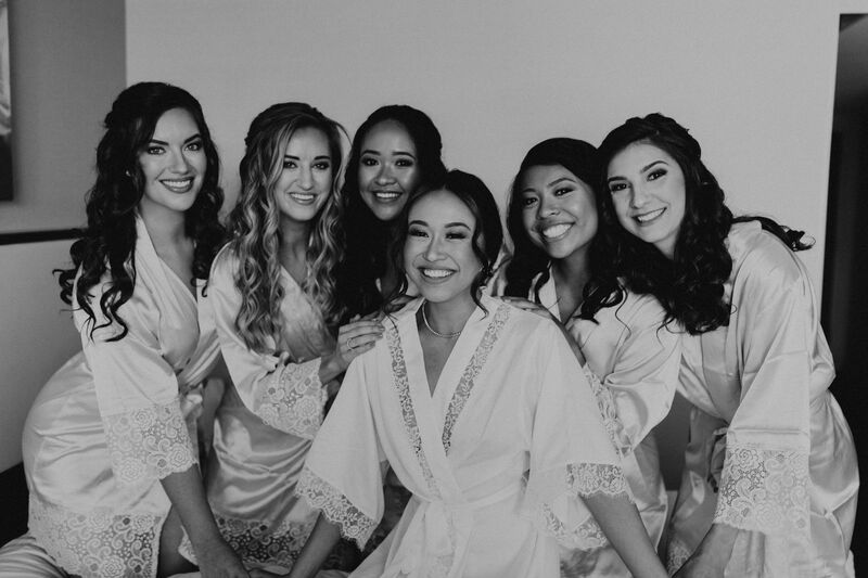 black and white photo of a Tampa bride with her wedding party in matching robes