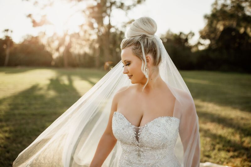 bride with a rhinestone encrusted wedding gown and long flowing veil at her Shakespearean inspired wedding