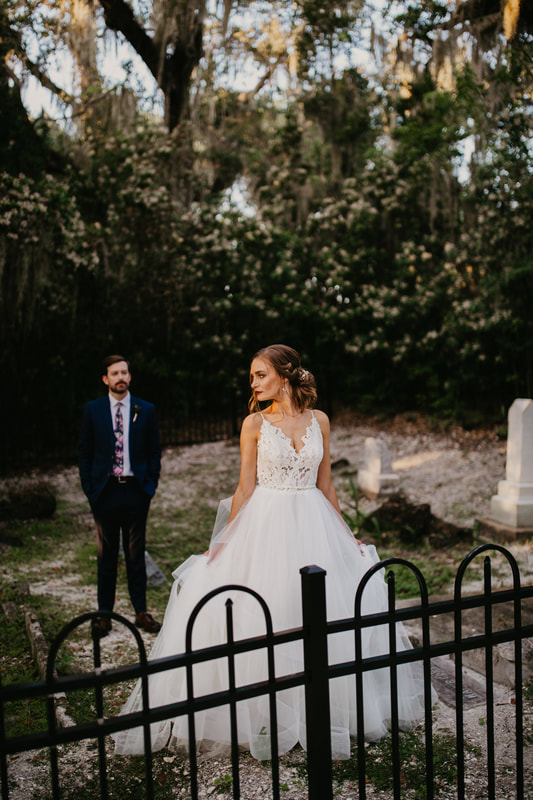 bride and groom posting for photos in historic cemetery
