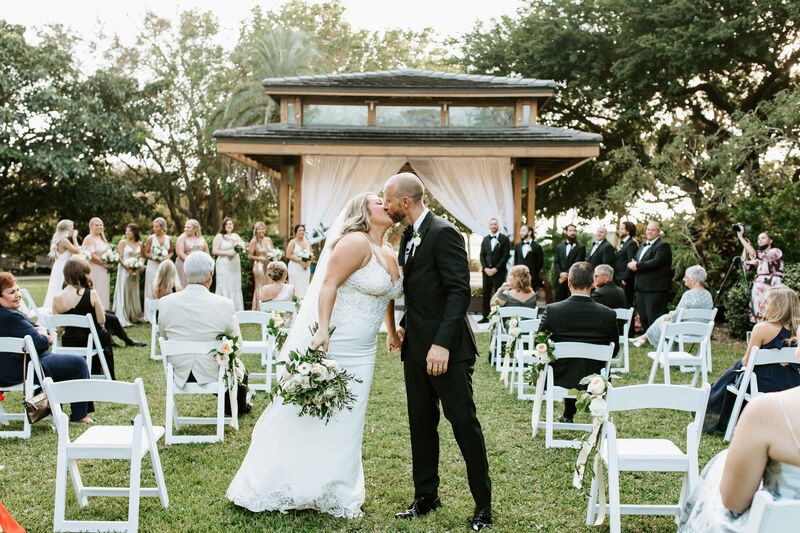 Bride and groom kissing after their outdoor wedding ceremony at Selby Gardens