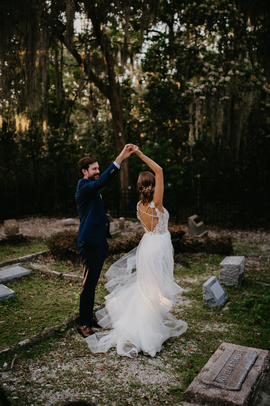 bride and groom dancing in historic cemetery