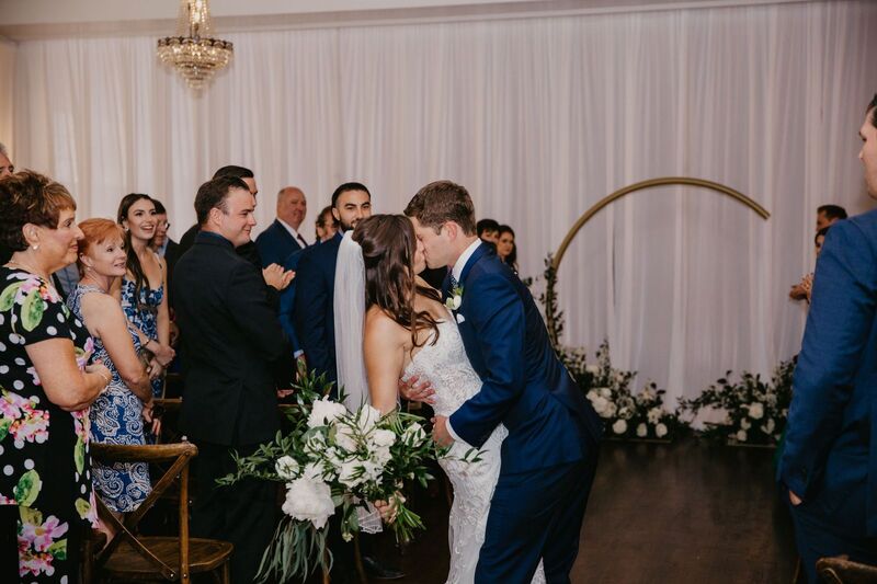Groom dipping his bride for a kiss after their wedding ceremony at The Orlo in Tampa