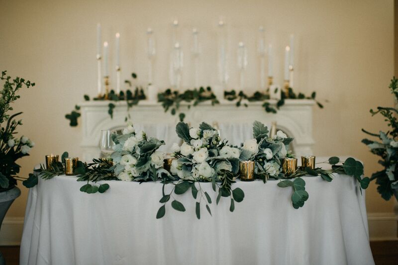 Sarasota wedding – Edson Keith Mansion wedding – Phillippi Estate Park wedding – Edson Keith Mansion – Phillippi Estate Park- Old Florida wedding – vintage inspired wedding – Sarasota wedding planner- Jennifer Matteo Event Planning- sweetheart table - white and sage sweetheart table - decorated mantle - mantle with taper candles - sweetheart table in front of mantel 
