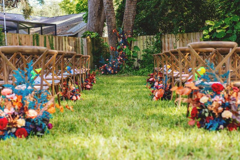 outdoor wedding ceremony with brightly colored flowers