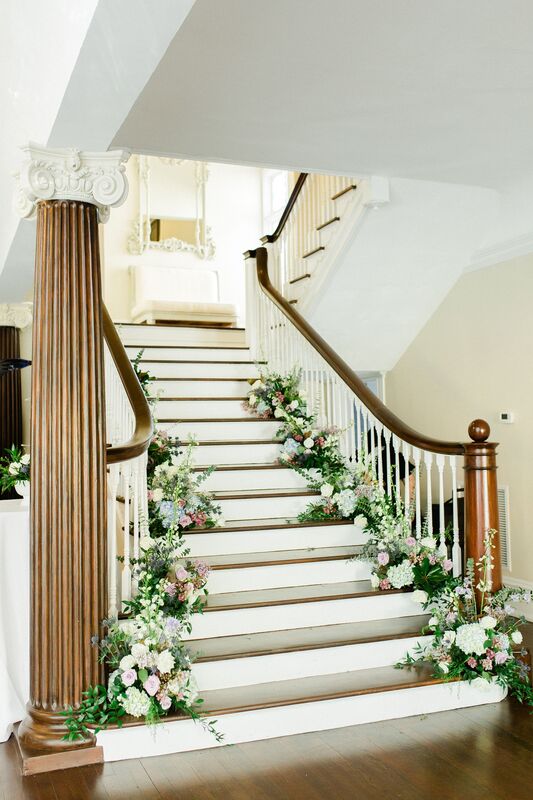 The stairs at The Orlo in Tampa filled with fresh flowers and candles