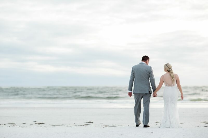 Sarasota wedding – Ringling wedding – Sarasota wedding planner – Sarasota luxury wedding planner – Orange wedding décor – Florida oranges in wedding décor - bride and groom on beach