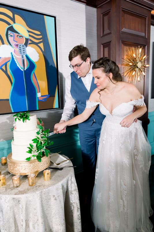Jennifer Matteo Event Planning -Saint Petersburg wedding – Vinoy wedding - bride and groom cutting wedding cake - three tiered white wedding cake. - white wedding cake on a gold cake stand