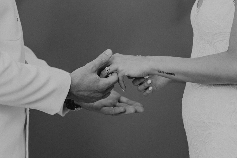 Closeup photo of bride and groom holding hands during their Tampa wedding ceremony